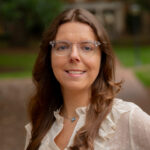 Carolina Housing staff member, Samantha McCord with brown hair wearing a white shirt, and clear glasses.